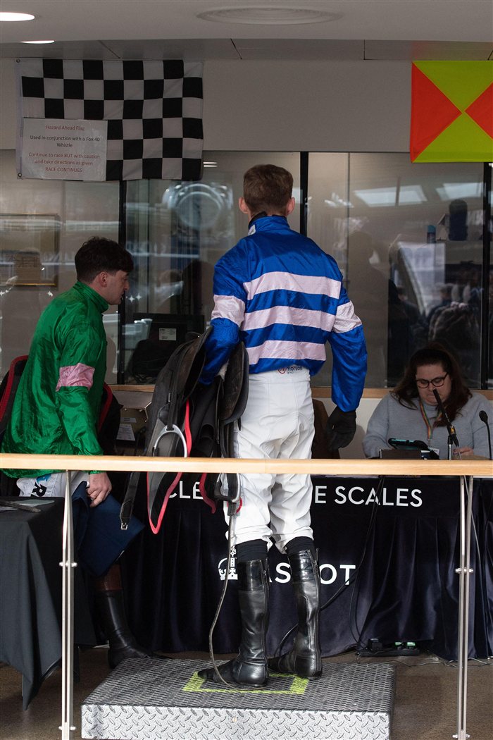 A jockey being weighed in after a race